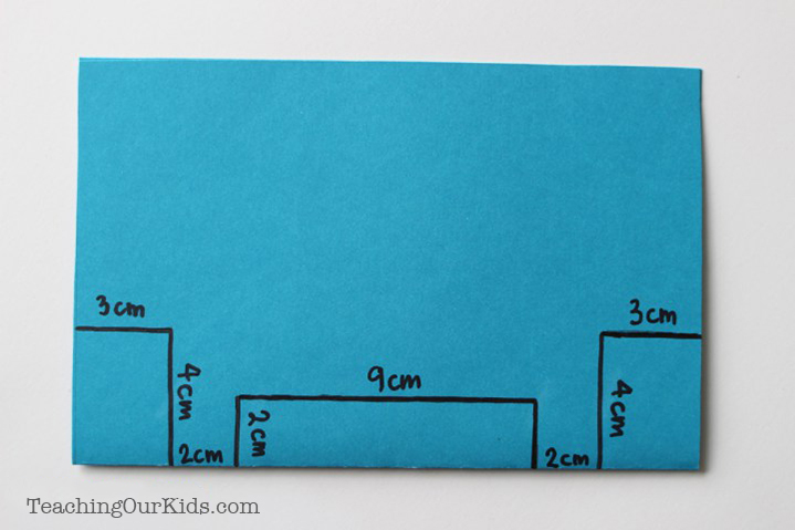 Measurements on a piece of blue cardstock paper