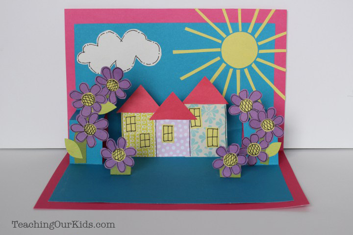 3D Pop-Up Card with cutout houses, sun, cloud, and flowers